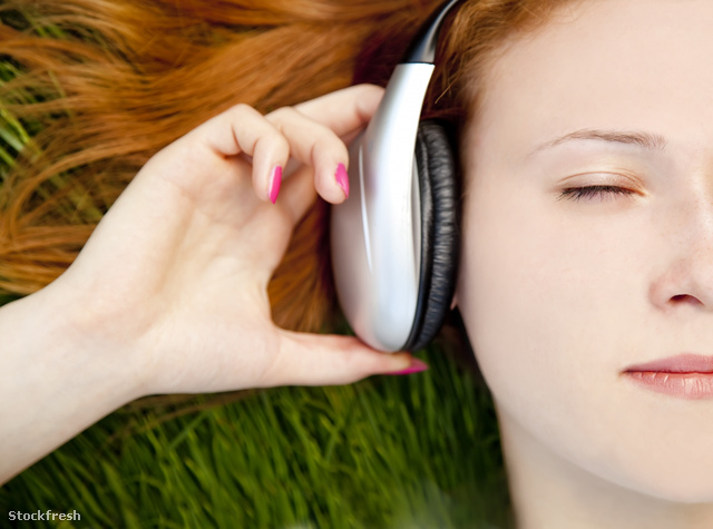 stockfresh 935386 redhead-girl-listening-music-at-green-grass si