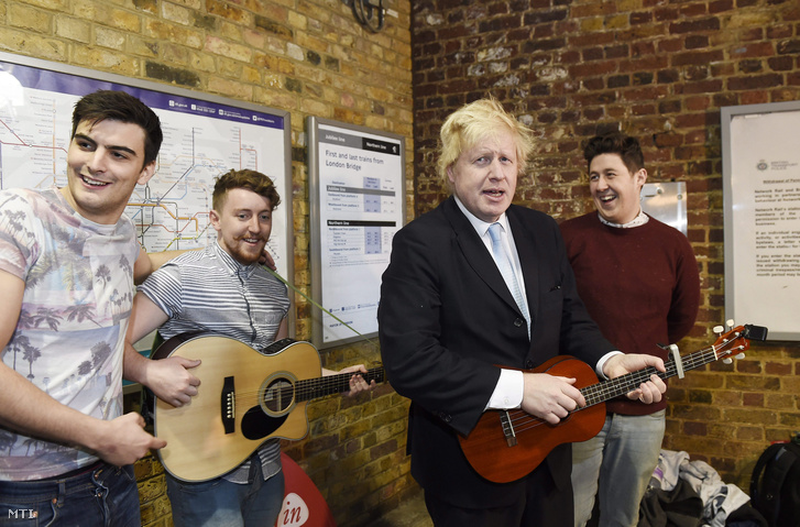 Boris Johnson London polgármestere (j2) utcai zenészek társaságában gitározik Londonban.