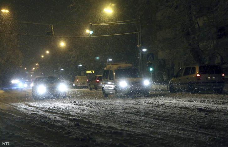 Autók haladnak a sűrű hóesésben Miskolc belvárosában a Görgey Artúr utcában 2016. január 15-én reggel.