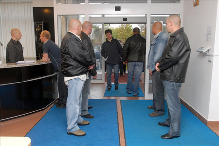 Biztonsági emberek sorfala között érkeznek a munkásgyűlésre a dolgozók