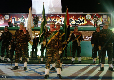 A Hamász palesztin iszlámista mozgalom fegyveresei izraeli zászlón állnak, amint egy al-Mabhúh tiszteletére tartott megemlékezésen vesznek részt Bét-Lahíjában 2010. február 17-én