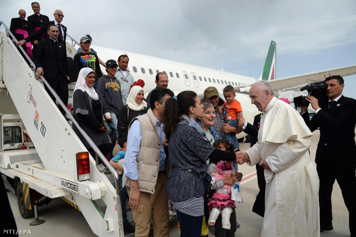 Ferenc pápa üdvözli a római Ciampino repülőtéren a 12 szíriai muzulmán menekültet, akiket magával hozott az égei-tengeri Leszbosz görög szigetről a Vatikánba 2016. április 16-án.
