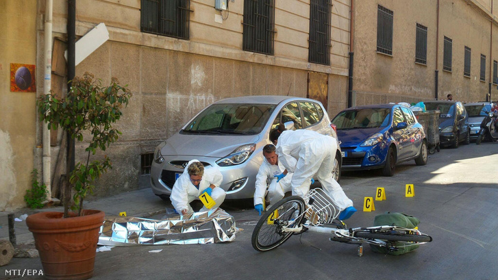 Helyszínelők Giuseppe Dainotti maffiafőnök letakart holtteste mellett Palermóban 2017. május 22-én.