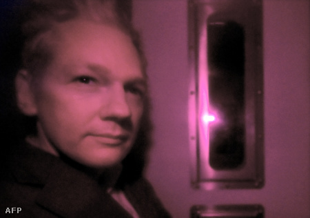 Julian Assange a sötétített üvegű rendőrségi furgon ablakán keresztül