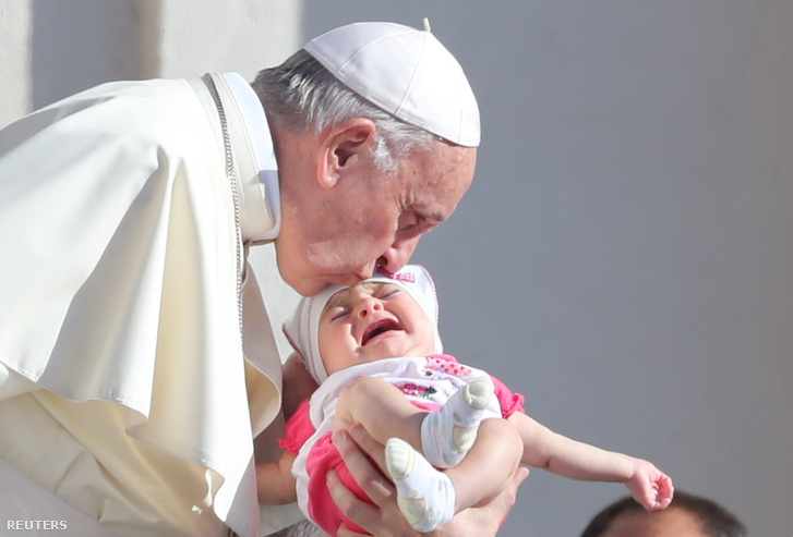 Ferenc pápa csókol meg egy gyermeket a Szent Péter téren.
