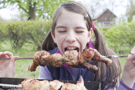 stockfresh 1026988 teen-girl-bites-grilled-meat-outdoors sizeM