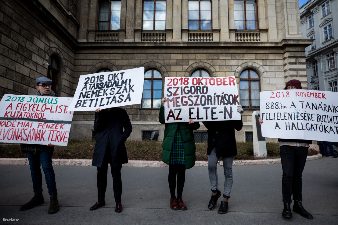 Demonstrators protesting against the academic policies of the Hungarian government at the Hungarian Academy of Science in Budapest on 12 February 2019. Signs: "July 2018: Figyelő lists researchers, and plans of taking away the Academy's funds," "October 2018: Ban on gender studies and strict austerity measures at ELTE," "November 2018: 888.hu urges students to report their teachers."