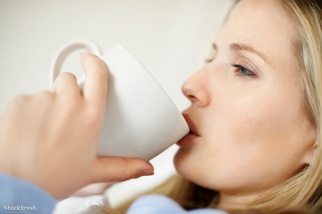 stockfresh 109060 detail-shot-of-a-sick-woman-drinking-tea-in-be
