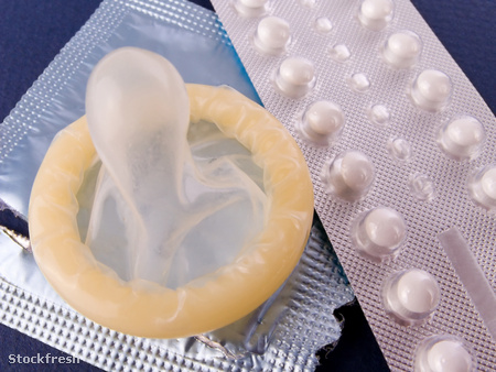 stockfresh 402681 birth-control-pills-and-a-condom-contraception