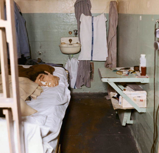 A börtöncella: az ágyon a kidekorált fej, a ruhadarabok mögött a kivájt szökési útvonal