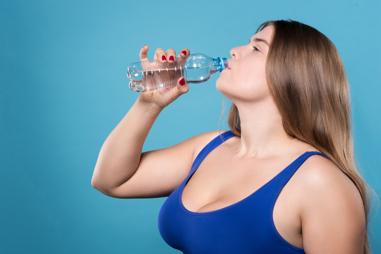 Запивать теплой водой. Толстая женщина пьет. Толстая женщина пьет воду. Пить воду. Много воды.