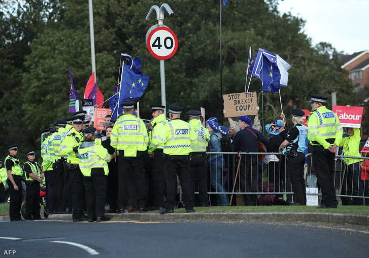 Police surround protesters against Brexit and against the government's policies with regards to Brexit as Britain's Prime Minister Boris Johnson gives a speech during a visit with the police in West Yorkshire northern England on 5 September 2019.