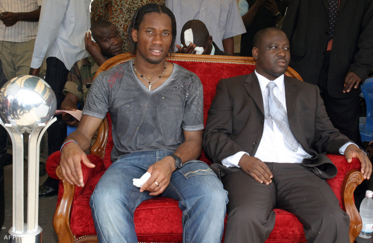 Didier Drogba és a lázadók vezetője, Guillaume Soro 2006-ban Bouake városban, mellettük a 26. Afrikai Aranylabda trófea. A focista az ország északi részébe tett látogatásán megköszönte szurkolói támogatását.