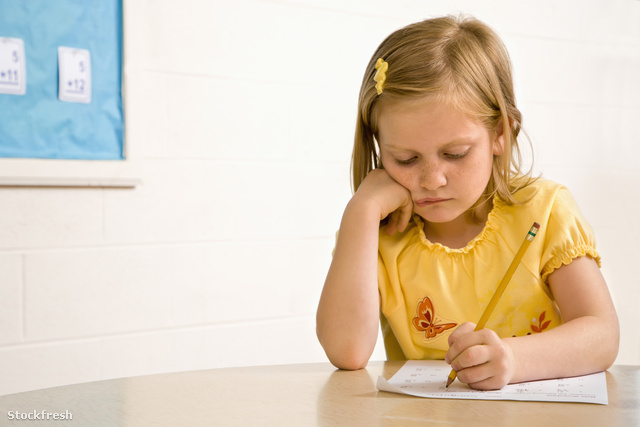 stockfresh 29032 young-girl-in-classroom-writing-on-paper sizeM