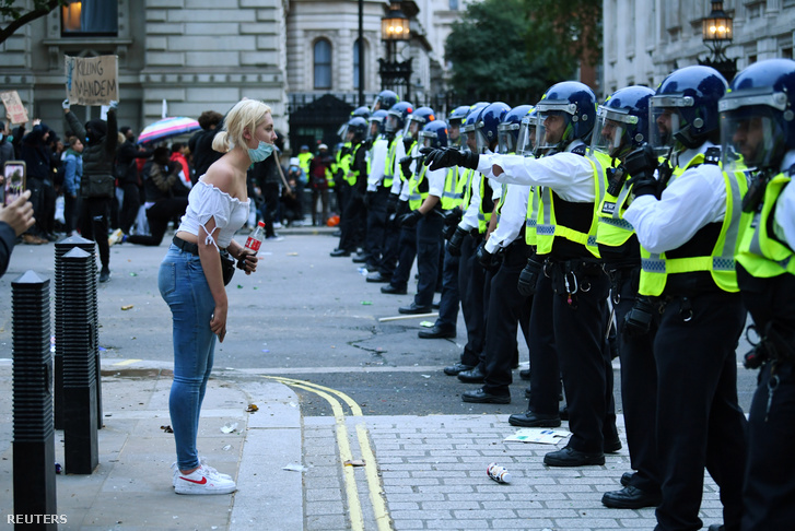 Rendőrök sorfala és egy tüntető a londoni Black Lives Matter tüntetésen 2020. június 7-én