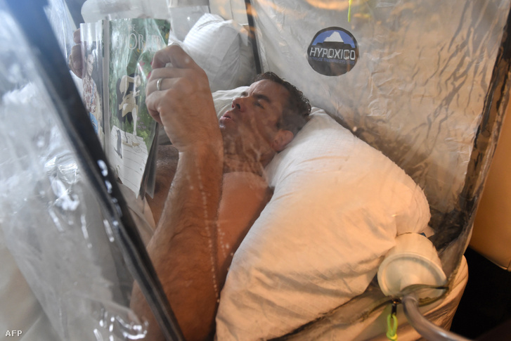 Caption:This picture taken on April 22 2017 shows Brooks Entwisle demonstrating the use of a pre-acclimatisation tent in his home as part of his training for his attempt to summit Mount Everest in Singapore. - For decades the dream of reaching the summit of Mount Everest has required at least two months on the mountain doing a series of acclimatisation rotations to get used to the harsh low-oxygen environment at the top of the world. Now pre-acclimatisation which has been at the fringes of the climbing world for several years is gaining traction dividing the community between those who see it as yet another tool of modern mountaineering and purists who dismiss it as a gimmick.