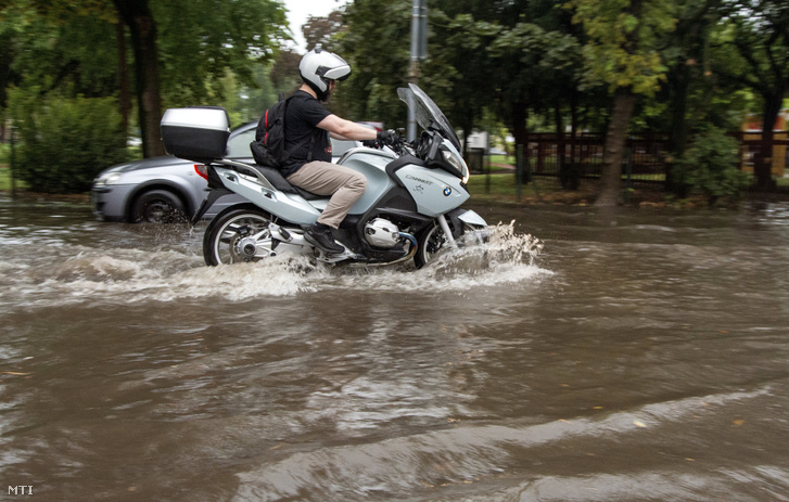 Motoros halad a heves zápor után esővízzel borított győri Bem téren 2020. augusztus 17-én