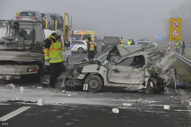 Rendőr helyszínel összeroncsolódott gépjárművek mellett az M5-ös autópálya Budapest felé tartó oldalán, Újhartyánnál, ahol négy autó összeütközött 2020. december 1-jén