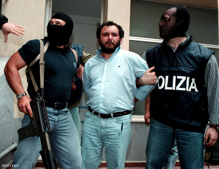 Álarcot visdelő maffiaellenes rendőrök kísérik Giovani Bruscát, amint elhagyja Palermo rendőrkapitányságát, hogy egy maximális biztonsági börtönbe vigyék
