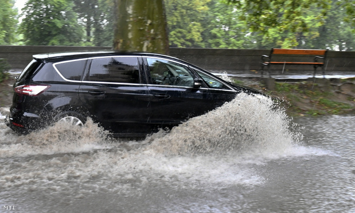 Autó halad a felhőszakadás miatt felgyülemlett esővízben Esztergom belvárosában 2021. augusztus 5-én