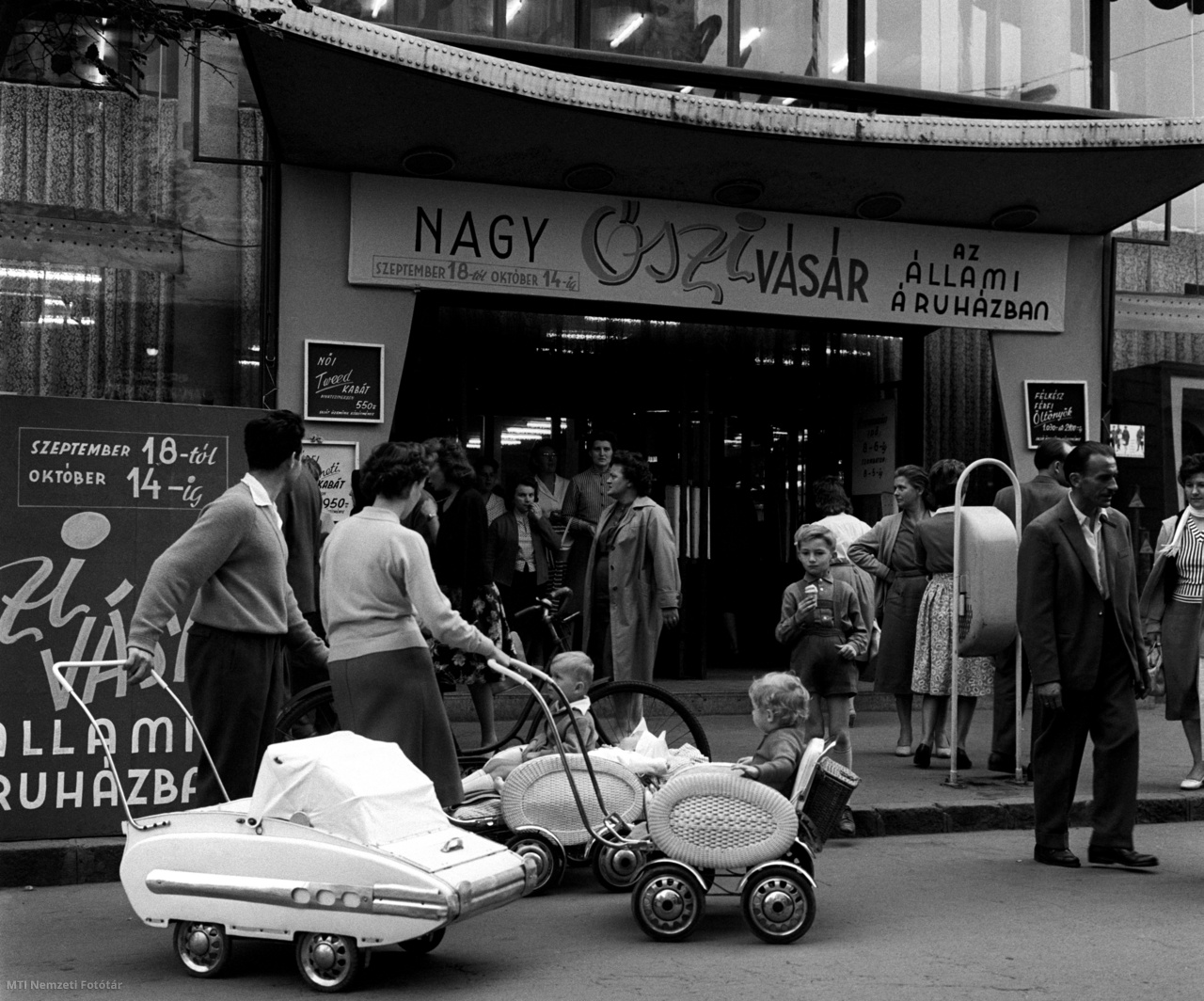 Győr, September 27, 1961 During the fall exhibition, shopkeepers and visitors push a stroller in front of the Győr State Department.  Győr is the economic and cultural center of northern Transnistria.  Its thriving industry, commerce and cultural amenities are worthy of the city's thousands of years of history as the seat of an important district of the country.
