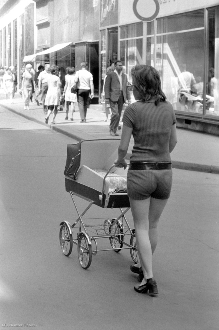 Budapest, May 15, 1971 A mother in fashionable shorts pushes a stroller down the street