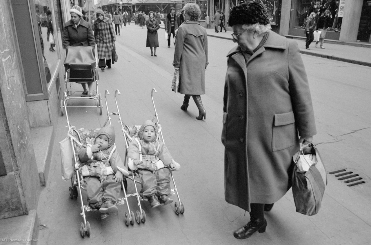 Budapest, December 2, 1982. An elderly woman is looking after twins in a trolley on Wasi Street.