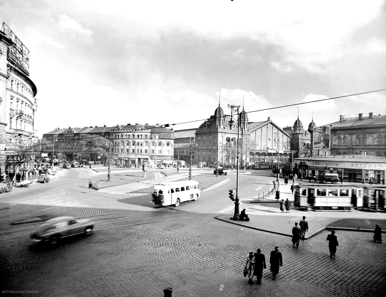 Budapest, June 1, 1953 View of Marx tér (after 1989 Nyugati tér), in the background Nyugati railway station was built according to the plans of Gustave Eiffel's company.  An Ikarus 30 bus and a Pobjeda car pass through the square.  To the right are R-type electric trailers at the terminus.