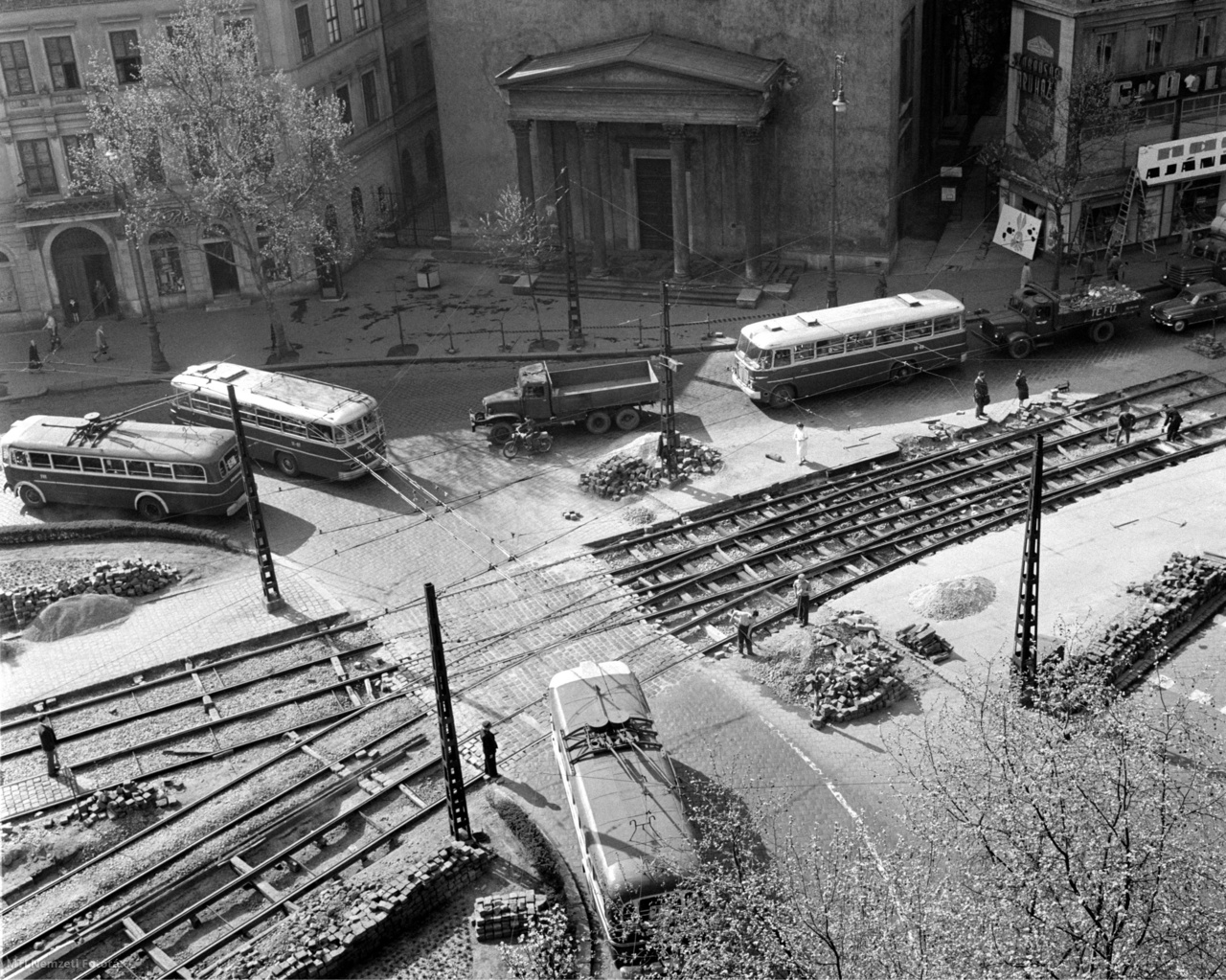 Budapest, April 23, 1962 The reconstruction of the tram tracks in Kálvin tér is nearing completion.  Higher traffic has necessitated the replacement of track bodies, with larger curved rails accelerating significantly in tram transport.  In the background is the entrance to the Calvin Square Reformed Church.