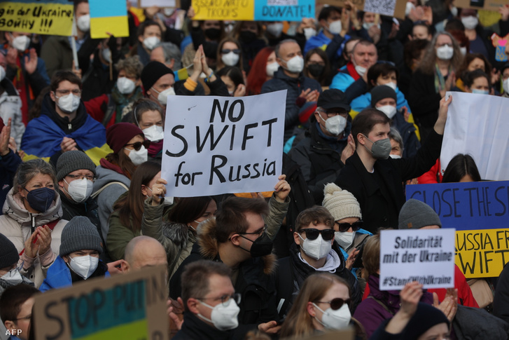 Egy tüntető No SWIFT for Russia feliratú plakátot tart egy tüntetésen 2022. február 26-án