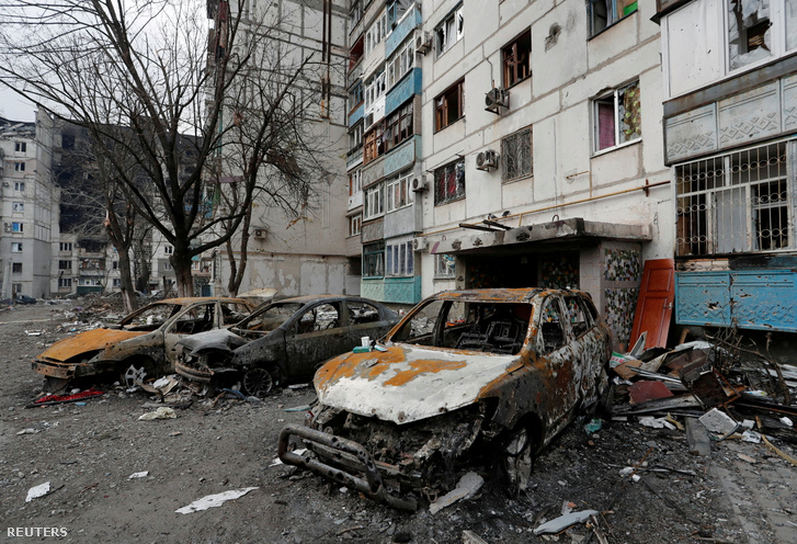 Megsemmisült autók egy lakóház előtt, a déli Mariupol kikötővárosban, Ukrajna 2022. március 27-én