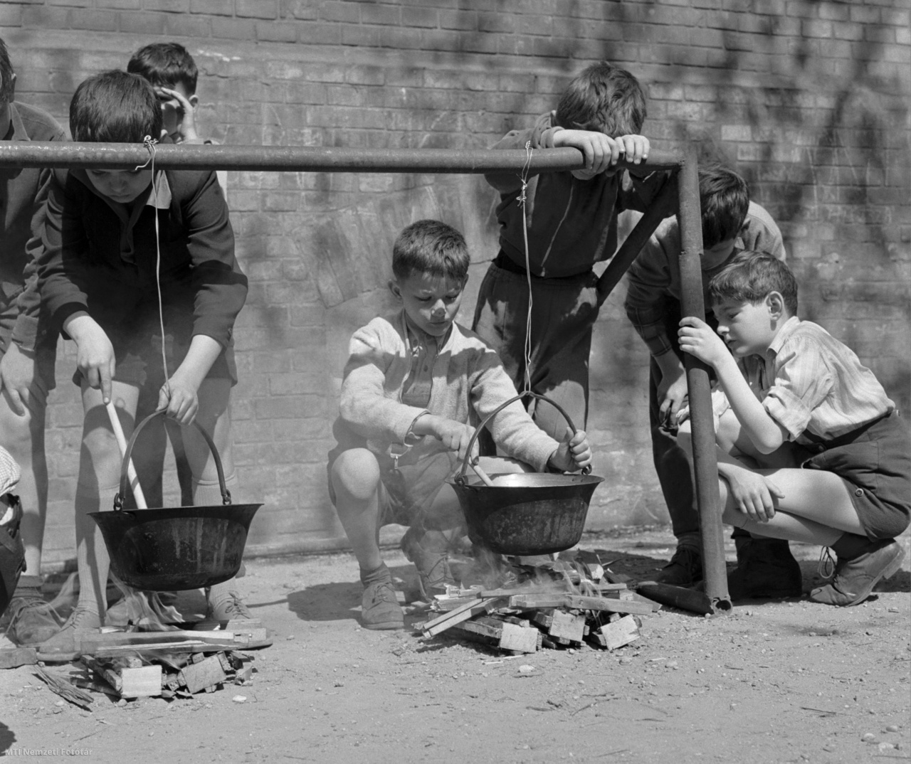Budapest, 1961. április 6. Paprikás krumplit főző úttörők az Apáczai Csere János Általános Iskola udvarán. A nyári tábor előkészületeként rendezett főzőversenyen húsz úttörő öt bográcsnál mutatta be, hogyan lehet 5 személyre jó paprikás krumplit készíteni. A győztesnek járó tábori szakács rangot a Párduc őrs tagjai nyerték meg.