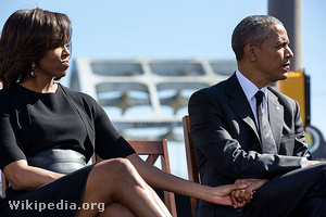 Barack and Michelle Obama holding hands at the event to commemor