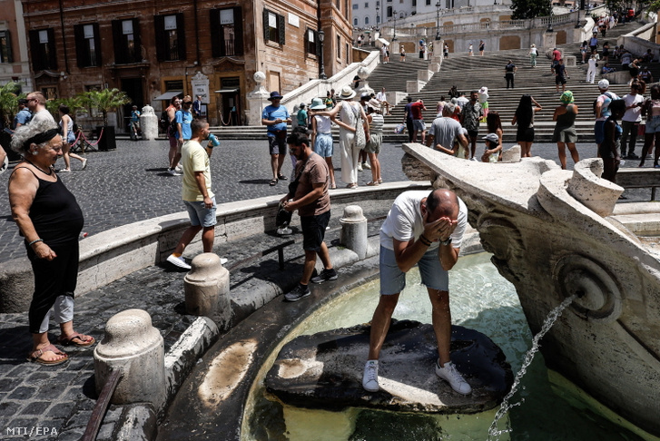 A római Bárka-szökőkút vizével hűsítik magukat emberek 2023. július 17-én, amikor hőhullám uralja Olaszországot