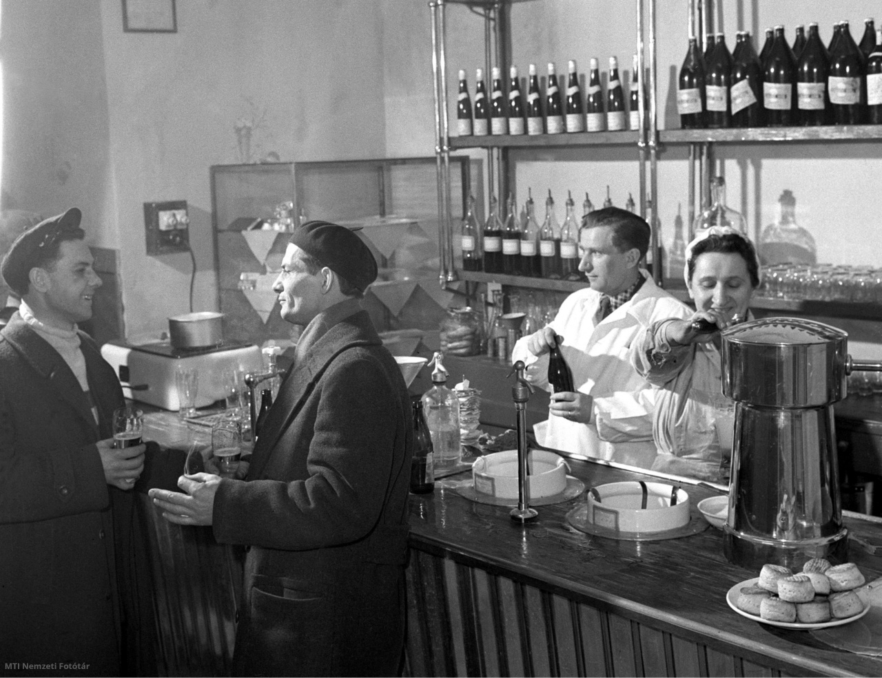 Budapest, 1959. február 13. Az új kiskocsma söntés része. Az I. és XII. kerületi Vendéglátóipari Vállalat vezetősége a dolgozók régi kívánságát teljesítette, amikor a Mészáros utcában megnyitotta Buda első fehér terítékes kiskocsmáját. Ebben a helyiségben korábban italbolt volt. Ezentúl a vendégeket fehér kabátos pincérek szolgálják ki, és neonvilágítás mellett fogyaszthatják kedvenc italukat a régi árakon. A kiskocsmában mostantól délben egytálétel is kapható