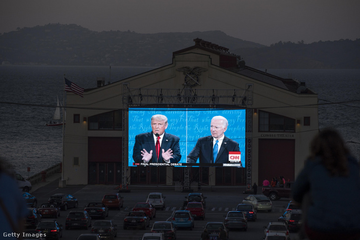 Az emberek 2020. október 22-én, a kaliforniai San Franciscóban, a Cowell Színház előtt nézik az utolsó amerikai elnökválasztási vitát Donald Trump elnök és Joe Biden demokrata jelölt között