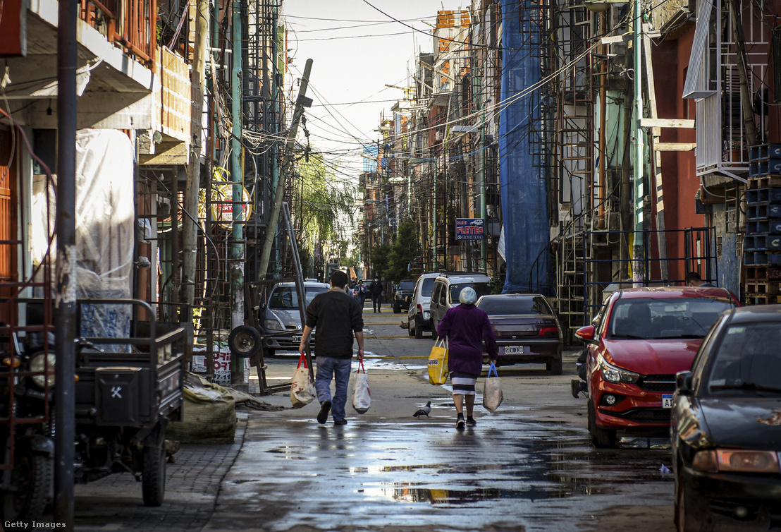 Emberek sétálnak bevásárlószatyrokkal Buenos Aires egyik utcáján 2020. május 8-án