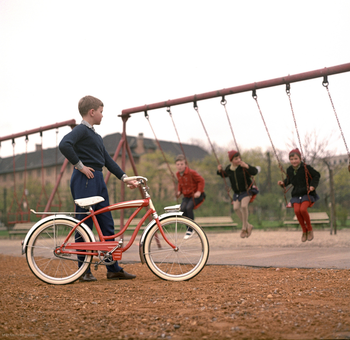 Budapest, 1967. április 8. Gyerekmodell a Csepel Kerékpárgyárban összeszerelt kerékpártípust reklámozza a Magyar Hirdető (MAHIR) számára készült felvételen Budán, a Feneketlen tónál lévő játszótéren. A háttérben a Kertészeti Egyetem épülete.