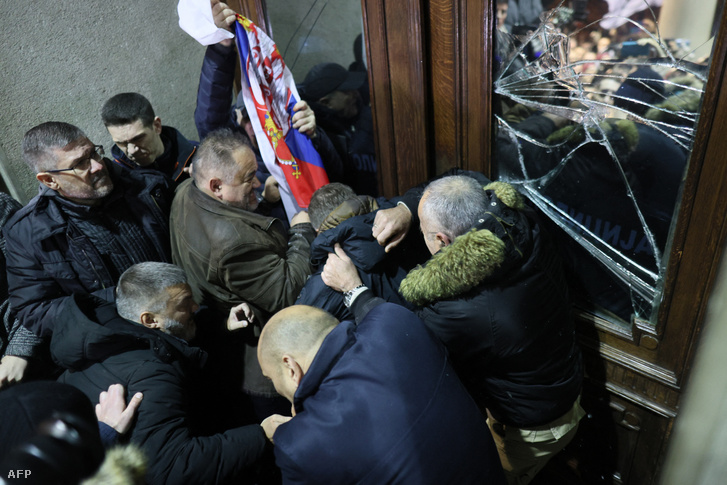 Az ellenzék támogatói megkísérelnek bejutni a belgrádi városi tanács épületébe a 2023. december 24-én