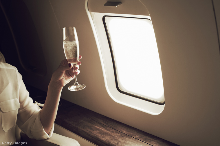 Illusztráció: Ismeretlen nő pezsgőzik egy magánrepülőgép fedélzetén. (Fotó: Flashpop / Getty Images Hungary)