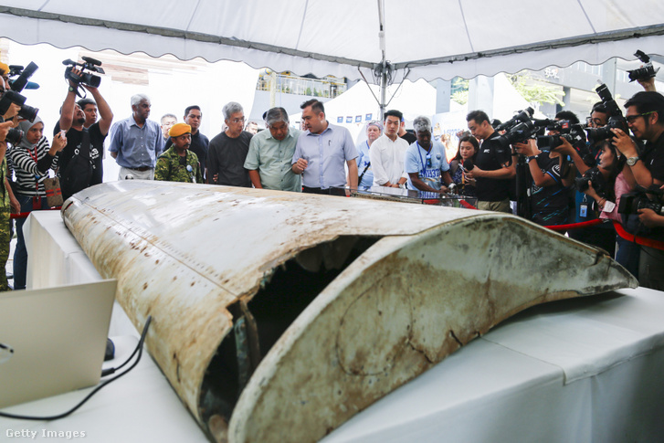 Anthony Loke (középen) malajziai közlekedési miniszter a partra mosott szárnyat nézi a Malaysia Airlines MH370-es járata eltűnésének 5. évfordulója alkalmából tartott megemlékezésen, amelyet az eltűnt Malaysia Airlines MH370-es járatának részeként azonosítottak a 9M-MRO-hoz visszavezetett egyedi alkatrészszámok alapján, Kuala Lumpurban, Malajziában 2019. március 3-án.