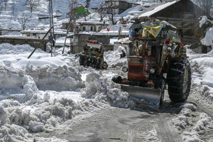 Traktorok tisztítják a hóval terhelt utakat Kalamban 2024. március 4-én