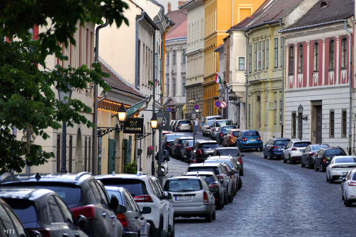 Műemlék épületek sorai a budai vár Úri utcájában a lakók parkoló személyautóival 2020. június 6-án