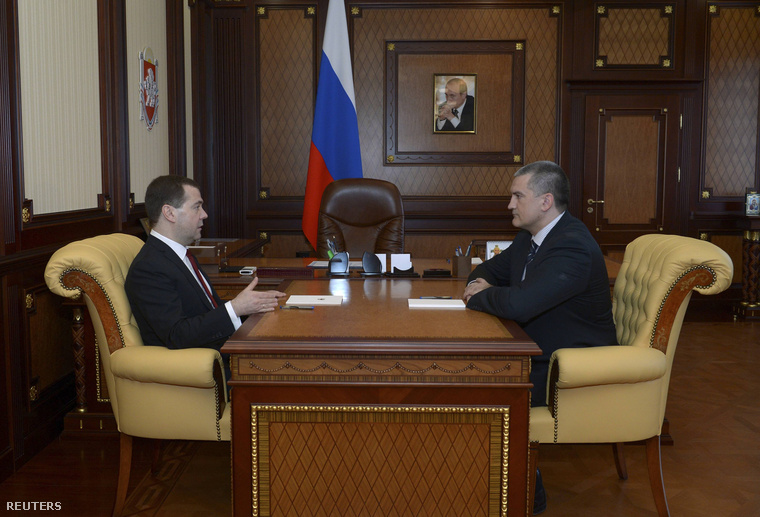 Medvegyev és Akszjonov - krími kormányfő - találkozója Szimferopolban, Vlagyimir Putyin portréja alatt