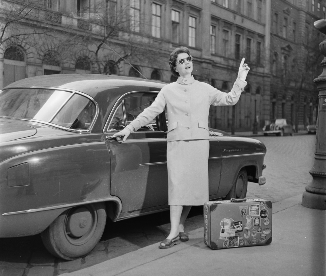 A Szent István tér déli oldala. Vitéz Eszter manöken egy Opel Kapitän személygépkocsi mellett áll, 1957